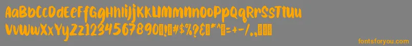 フォントCAIBOJOGRegular – オレンジの文字は灰色の背景にあります。