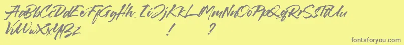 フォントCallaghands – 黄色の背景に灰色の文字