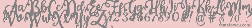 Fonte Calligraphy Stye – fontes cinzas em um fundo rosa