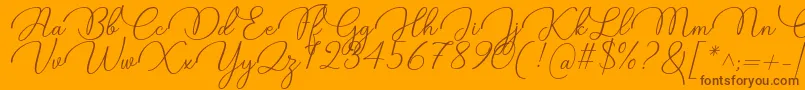 Czcionka Candire Font by 7NTypes – brązowe czcionki na pomarańczowym tle