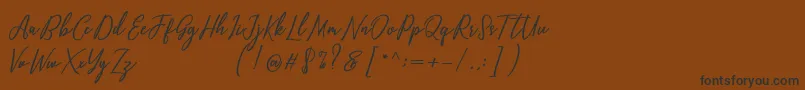 Capital Script Font – Black Fonts on Brown Background
