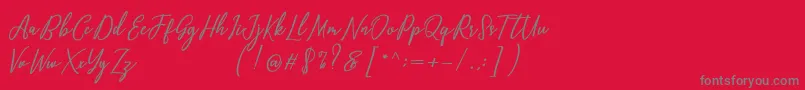 フォントCapital Script – 赤い背景に灰色の文字
