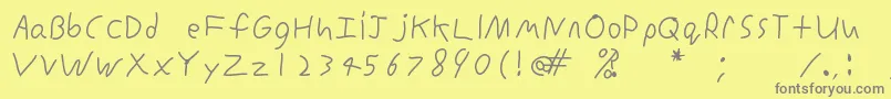 フォントInconsistentprintRegular – 黄色の背景に灰色の文字