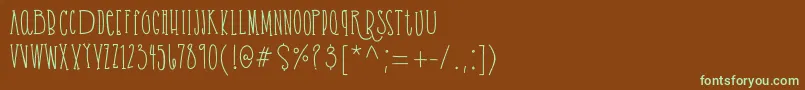 フォントCassandrabold demo – 緑色の文字が茶色の背景にあります。
