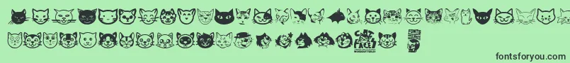 Fonte Cat Faces – fontes pretas em um fundo verde