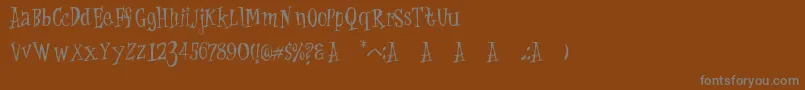 Cat Krap-Schriftart – Graue Schriften auf braunem Hintergrund