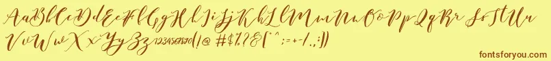 Czcionka Catandra Brush Script – brązowe czcionki na żółtym tle