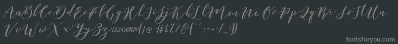 Fonte Catandra Brush Script – fontes cinzas em um fundo preto