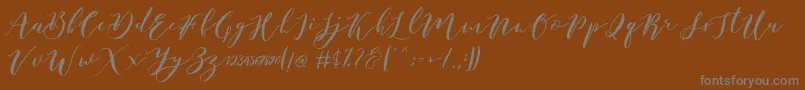 フォントCatandra Brush Script – 茶色の背景に灰色の文字