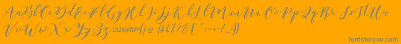 Fonte Catandra Brush Script – fontes cinzas em um fundo laranja
