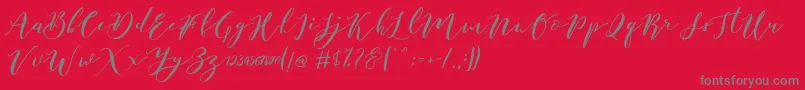 Czcionka Catandra Brush Script – szare czcionki na czerwonym tle