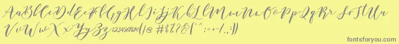 フォントCatandra Brush Script – 黄色の背景に灰色の文字