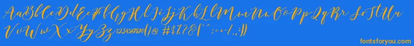 Catandra Brush Script-fontti – oranssit fontit sinisellä taustalla