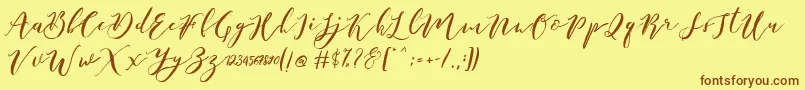 フォントCatandra Brush Script – 茶色の文字が黄色の背景にあります。