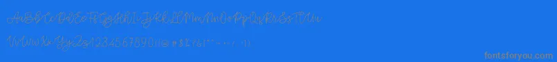 フォントCattomscute – 青い背景に灰色の文字