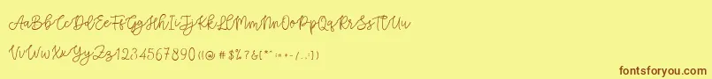フォントCattomscute – 茶色の文字が黄色の背景にあります。