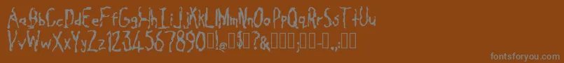 フォントCavity Regular – 茶色の背景に灰色の文字