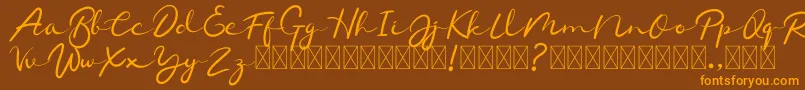 フォントChamelon – オレンジ色の文字が茶色の背景にあります。