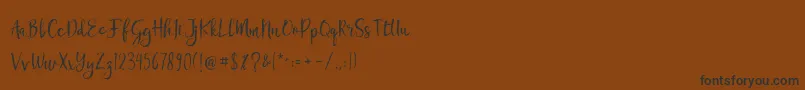 Chamille-Schriftart – Schwarze Schriften auf braunem Hintergrund