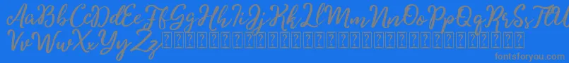 Charitta-Schriftart – Graue Schriften auf blauem Hintergrund