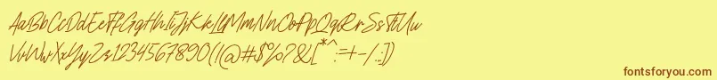 フォントCharlion Slant Script – 茶色の文字が黄色の背景にあります。