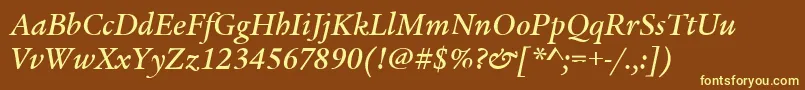 LegacySerifItcMediumItalic-fontti – keltaiset fontit ruskealla taustalla