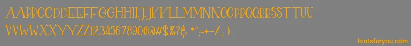 フォントCHEKIDOT – オレンジの文字は灰色の背景にあります。
