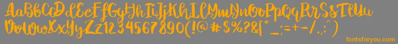 Chelsea Brush Script-Schriftart – Orangefarbene Schriften auf grauem Hintergrund