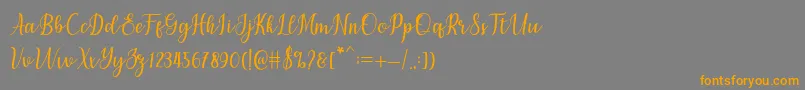 フォントchetlie – オレンジの文字は灰色の背景にあります。