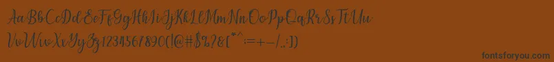 フォントchetlie – 黒い文字が茶色の背景にあります