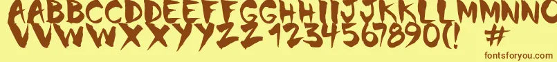 フォントChinela Brush – 茶色の文字が黄色の背景にあります。