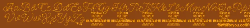 フォントChristmasMiracle PERSONAL – オレンジ色の文字が茶色の背景にあります。