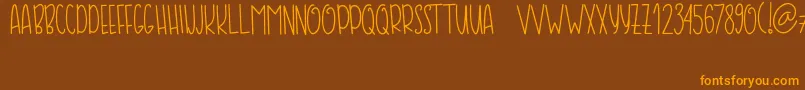 COFFE  MILK-Schriftart – Orangefarbene Schriften auf braunem Hintergrund