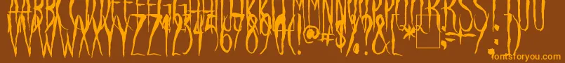 フォントRavenSong – オレンジ色の文字が茶色の背景にあります。
