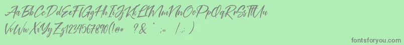 フォントCoral Pen Free – 緑の背景に灰色の文字