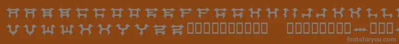 COSMBV  -fontti – harmaat kirjasimet ruskealla taustalla