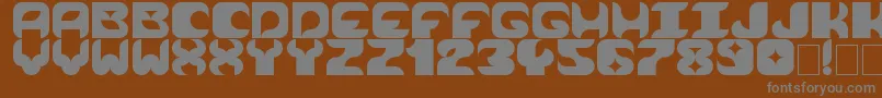 Cosmik Orchestra-fontti – harmaat kirjasimet ruskealla taustalla