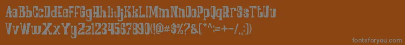 COWBOYZ-fontti – harmaat kirjasimet ruskealla taustalla