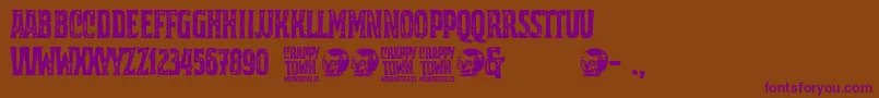 Crappy Town-Schriftart – Violette Schriften auf braunem Hintergrund
