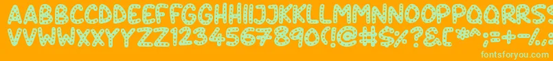 Crazy Dots-Schriftart – Grüne Schriften auf orangefarbenem Hintergrund