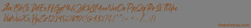 フォントCrushed – 茶色の文字が灰色の背景にあります。