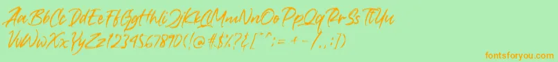 フォントCrushed – オレンジの文字が緑の背景にあります。