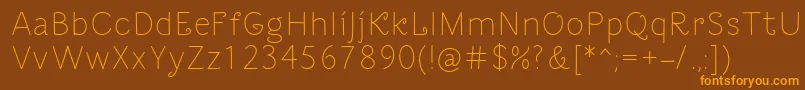 フォントDacha – オレンジ色の文字が茶色の背景にあります。