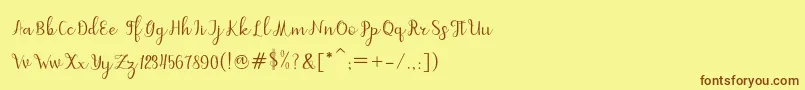 フォントdahlia script – 茶色の文字が黄色の背景にあります。