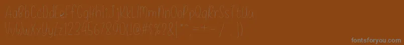 DaisyRae Thin-Schriftart – Graue Schriften auf braunem Hintergrund