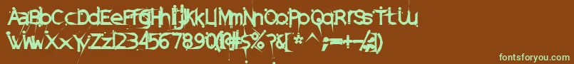 フォントDamagedSataLightExtended – 緑色の文字が茶色の背景にあります。