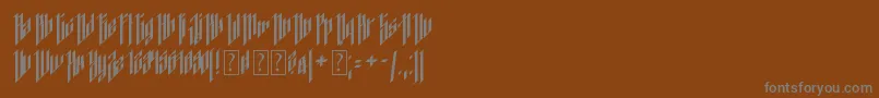 Dancing DL1 0-Schriftart – Graue Schriften auf braunem Hintergrund