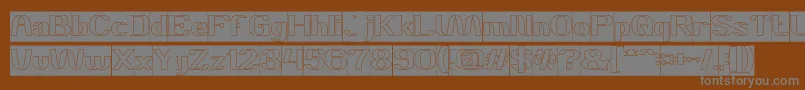 DANIEL Hollow Inverse-fontti – harmaat kirjasimet ruskealla taustalla