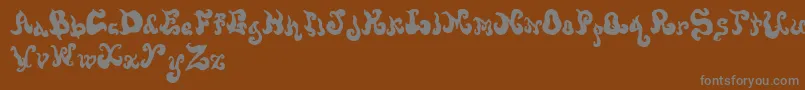 フォントScrewy – 茶色の背景に灰色の文字
