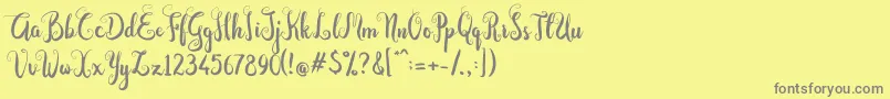 フォントDastan Script – 黄色の背景に灰色の文字